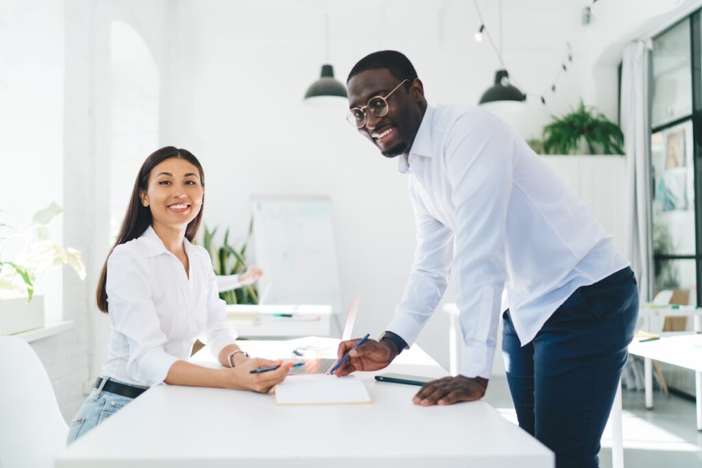 Two cheerful colleagues look to you to develop management strategy.