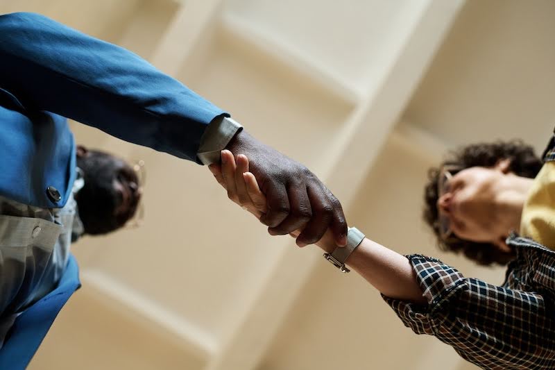 two men shake hands because of their in demand jobs