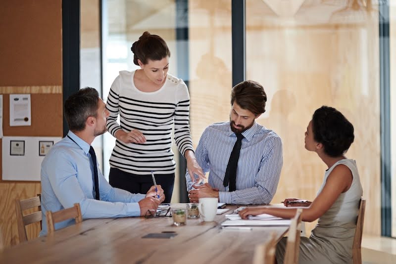 a group of project managers are in a meeting