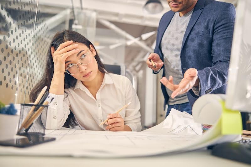 a temporary worker is frustrated with her work at her desk