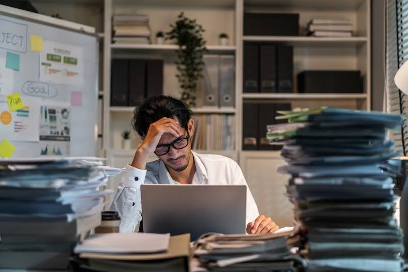 man at a desk thinking about when to hire freelance workers