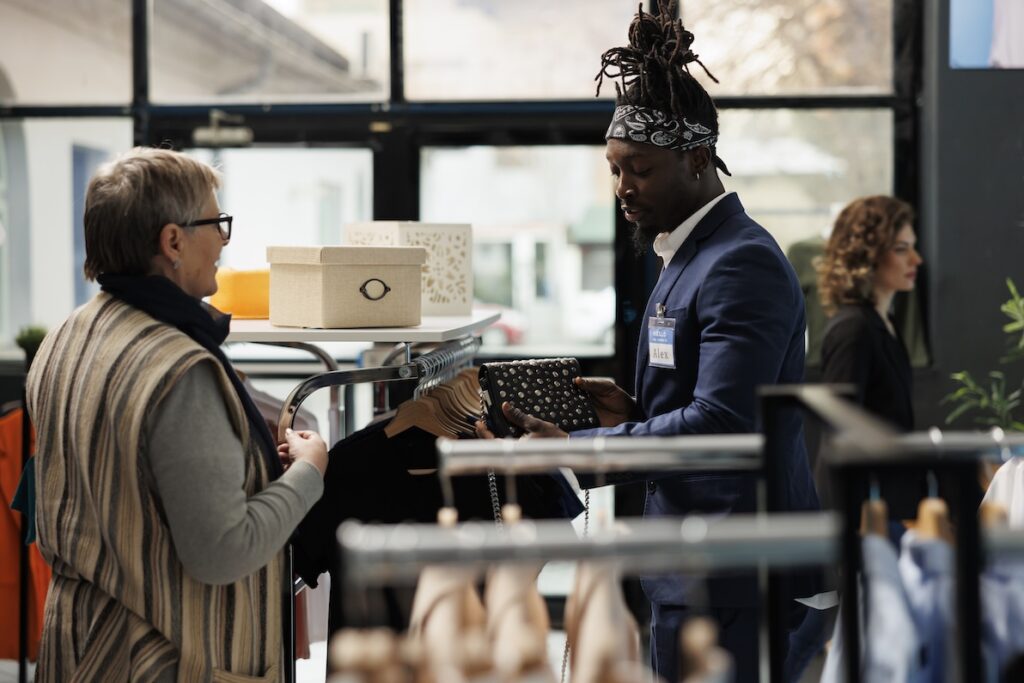 A young man works at a boutique in one of the best part time careers for students.