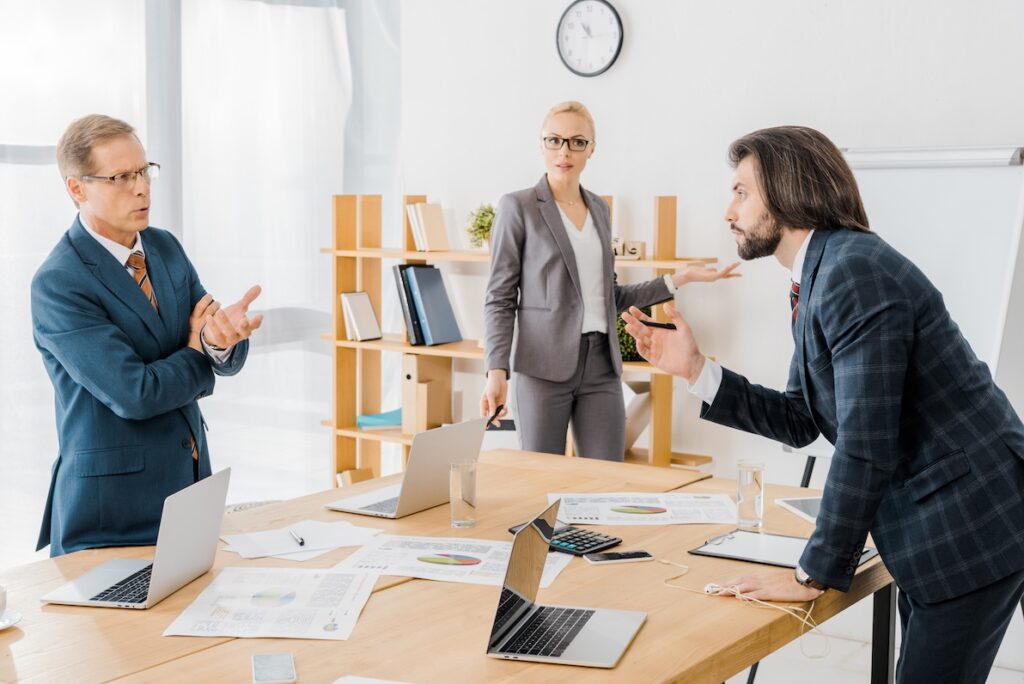 Two co-workers argue in a heated debate that could be helped through holistic conflict resolution.