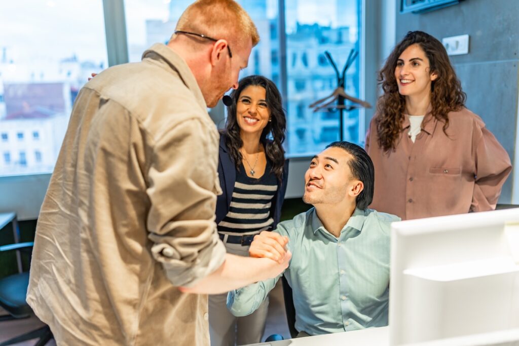 Two male collegues embrace respectfully as a sign of emotional intelligence.